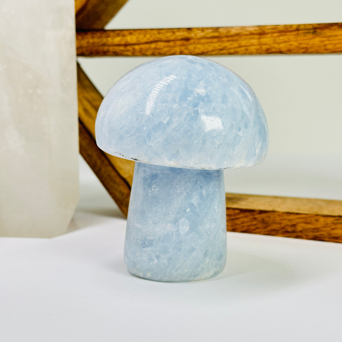 blue calcite mushroom with decorations in the background