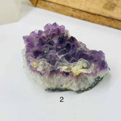 amethyst cluster with decorations in the background