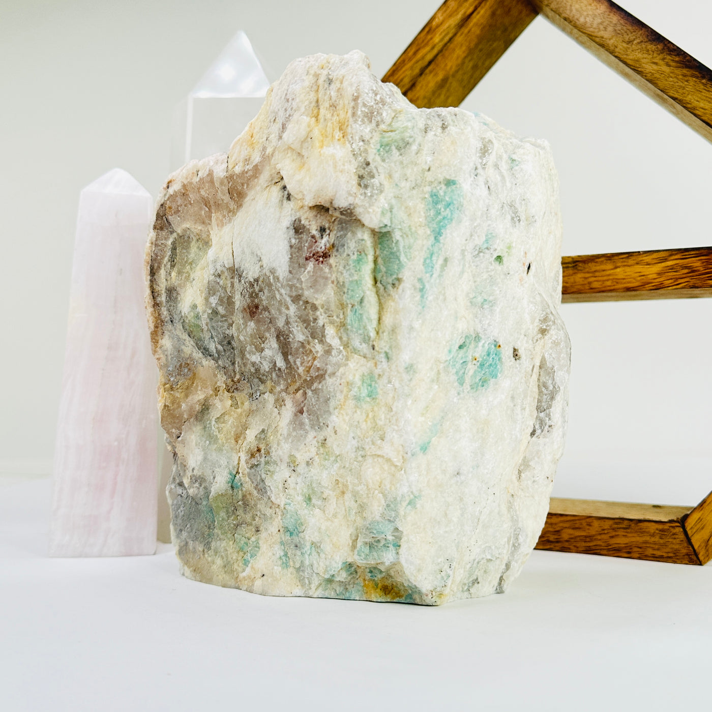 amazonite cut base with decorations in the background