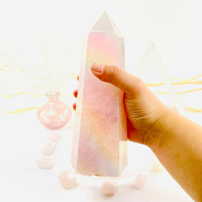 Angel Aura Rose Quartz Generator with Natural Inclusions in hand for size reference
