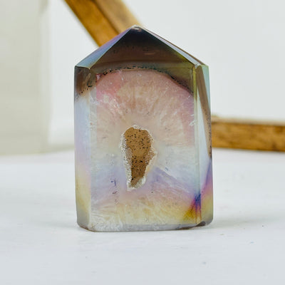 angel aura agate point with decorations in the background