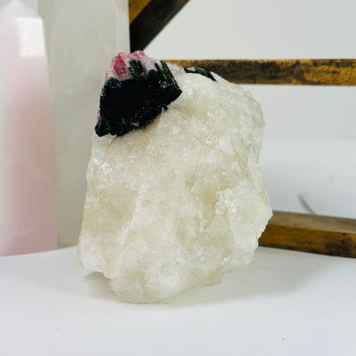 watermelon tourmaline with decorations in the background