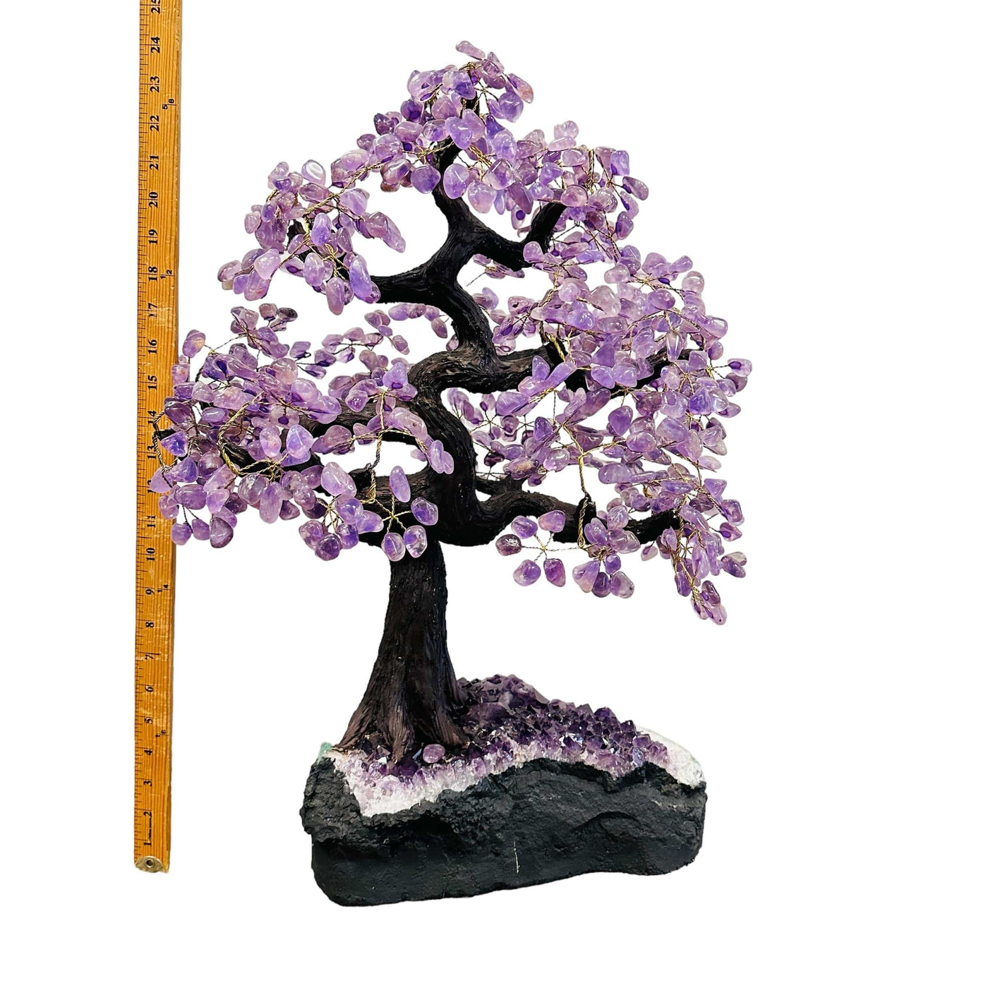 amethyst tree on amethyst base next to a ruler for size reference