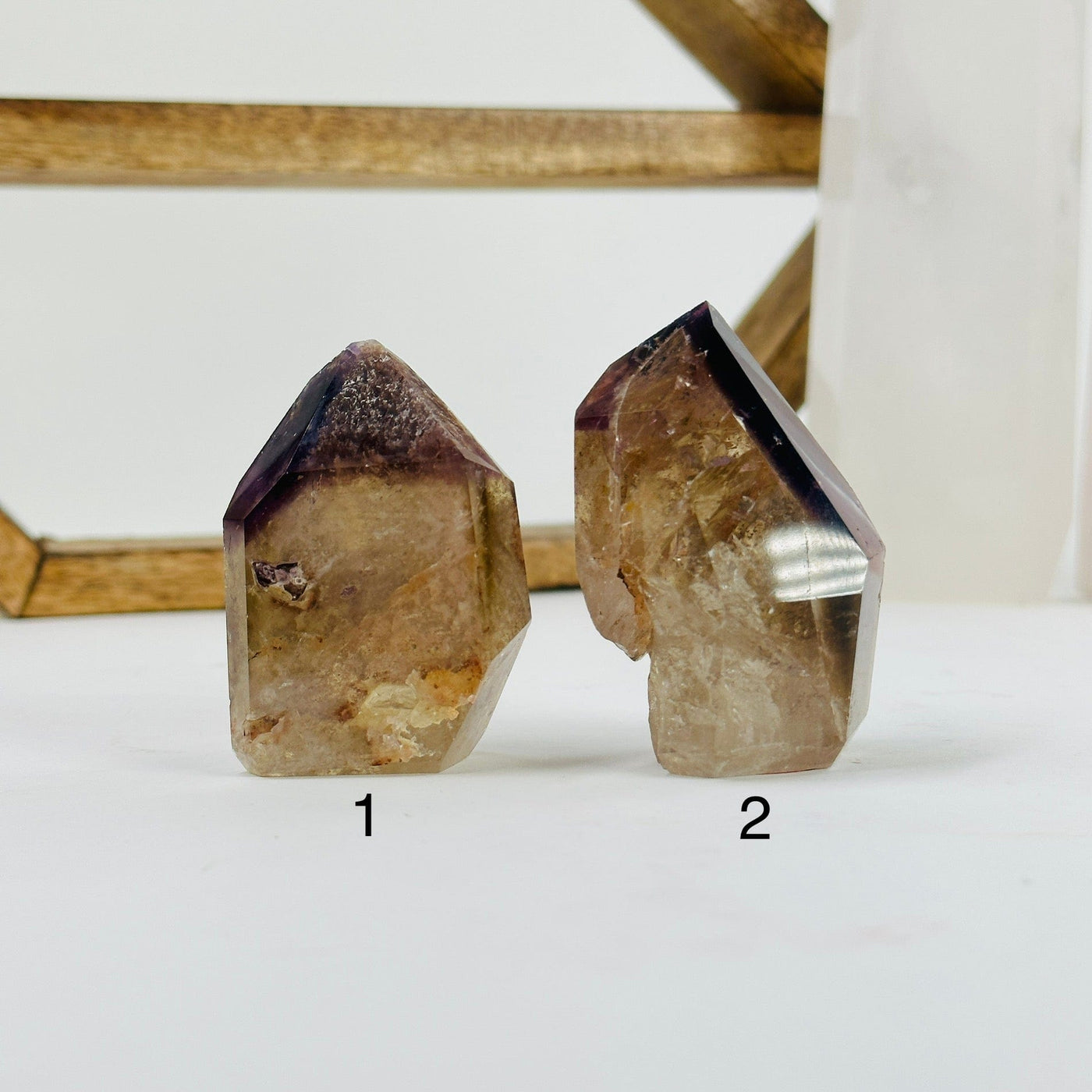 ametrine polished points with decorations in the background