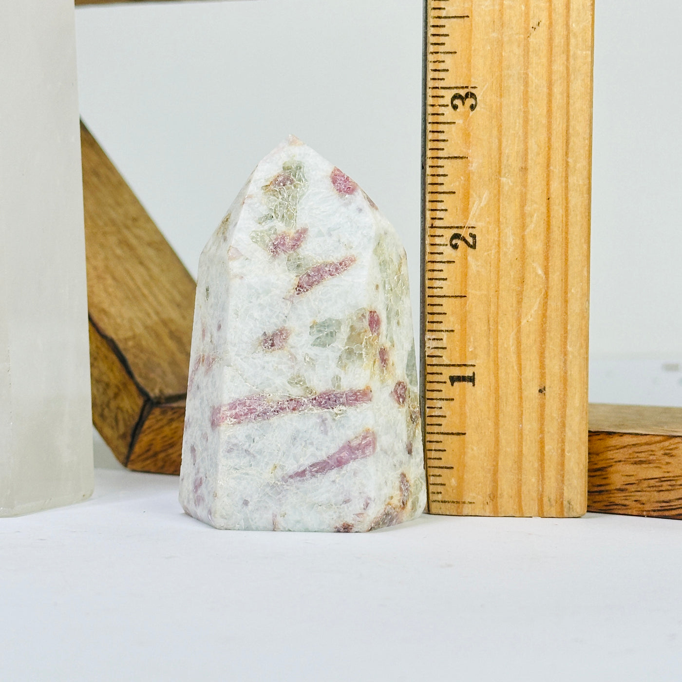 tourmaline point next to a ruler for size reference