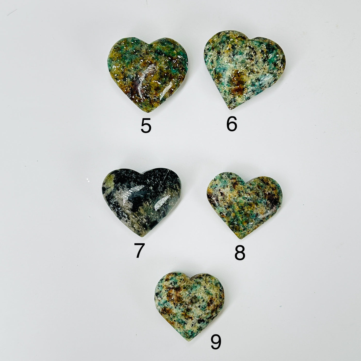 amazonite heart with decorations in  the background