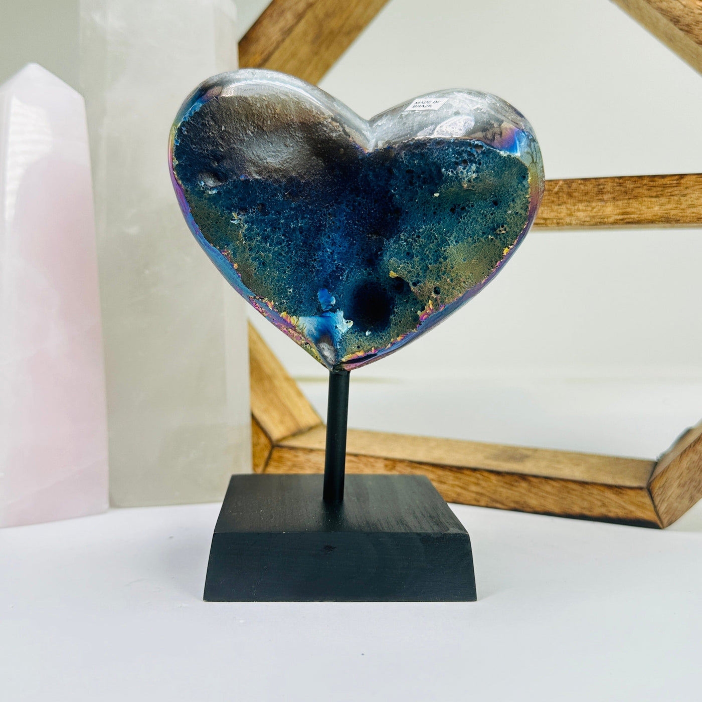 amethyst heart on stand with decorations in the background