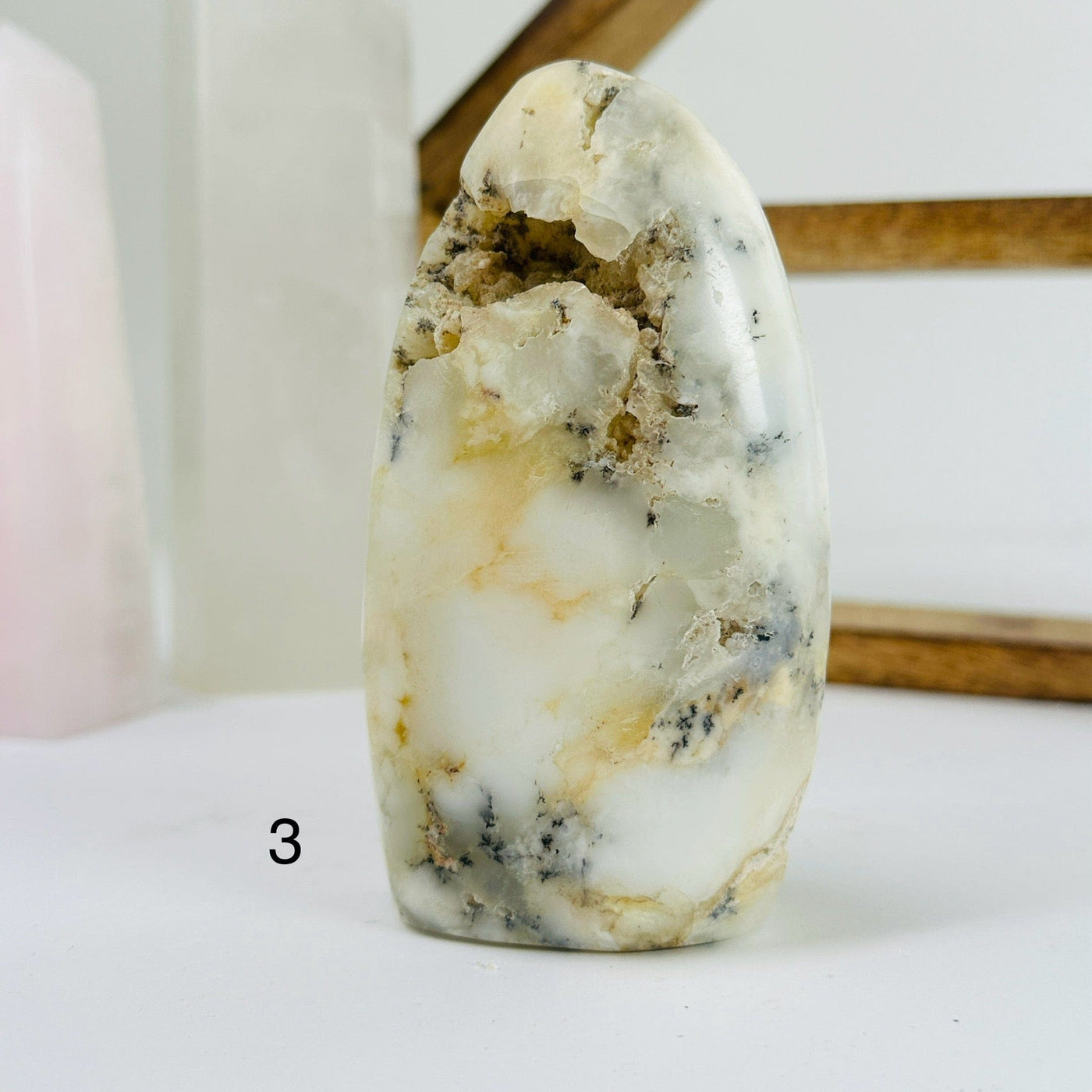 Dendrite opal cut base with decorations in the background