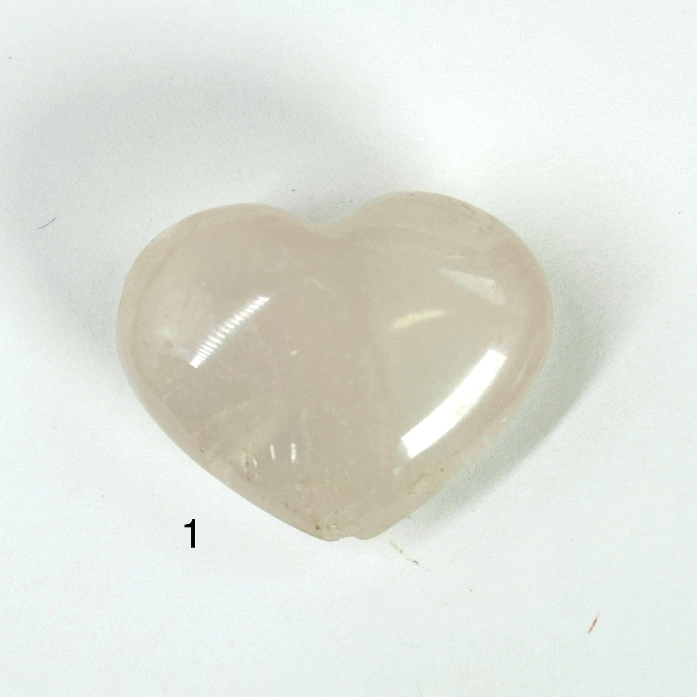 rose quartz heart on white background