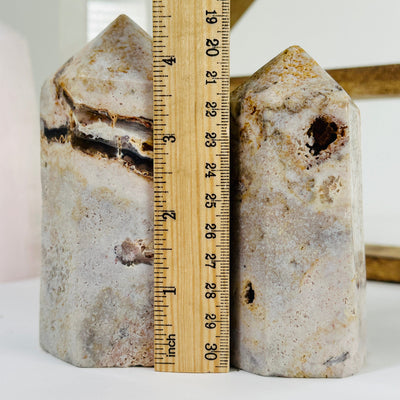 pink amethyst point next to a ruler for size reference