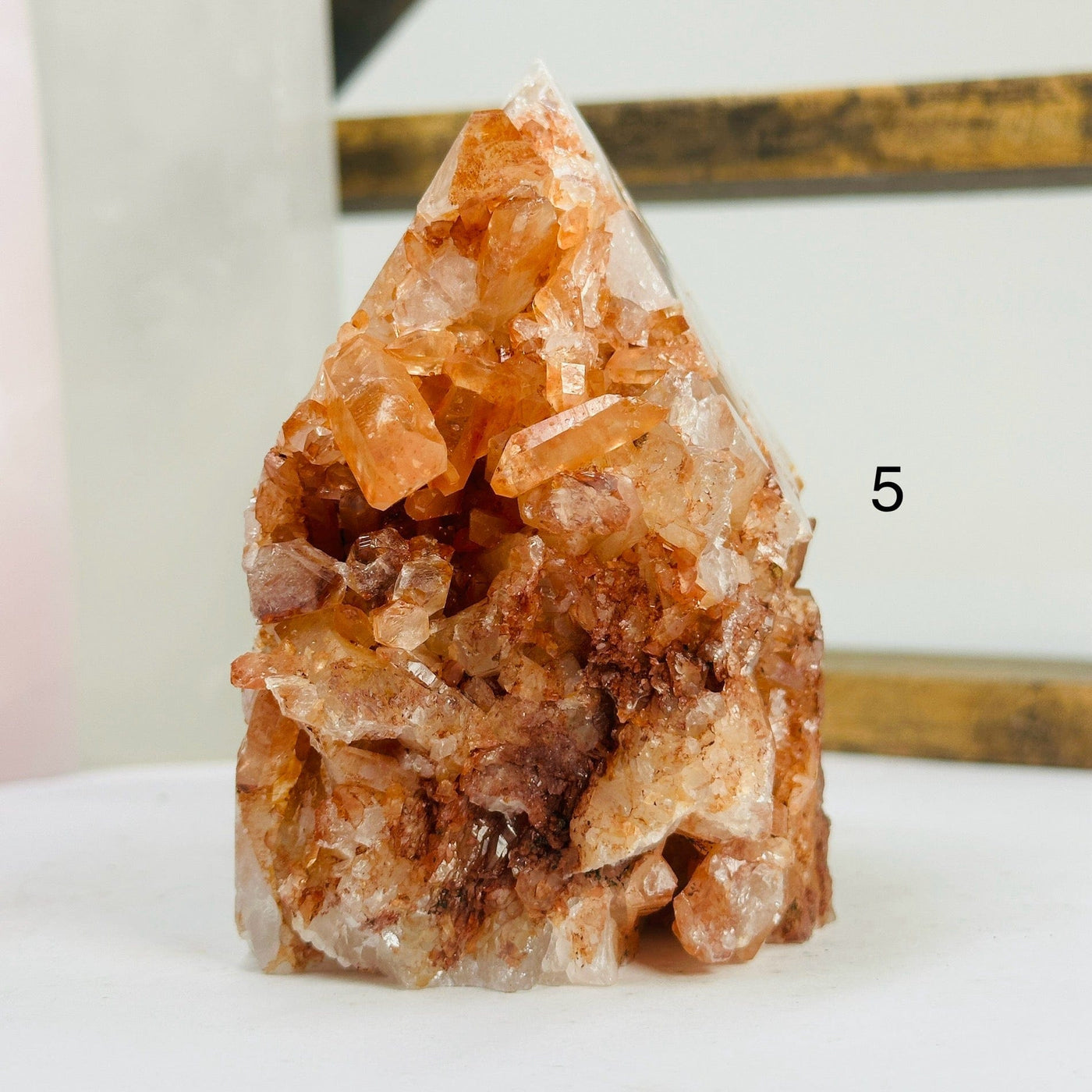 tangerine quartz points with decorations in the background