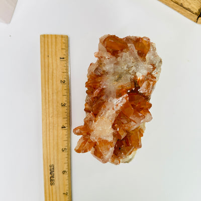 tangerine quartz with decorations in the background