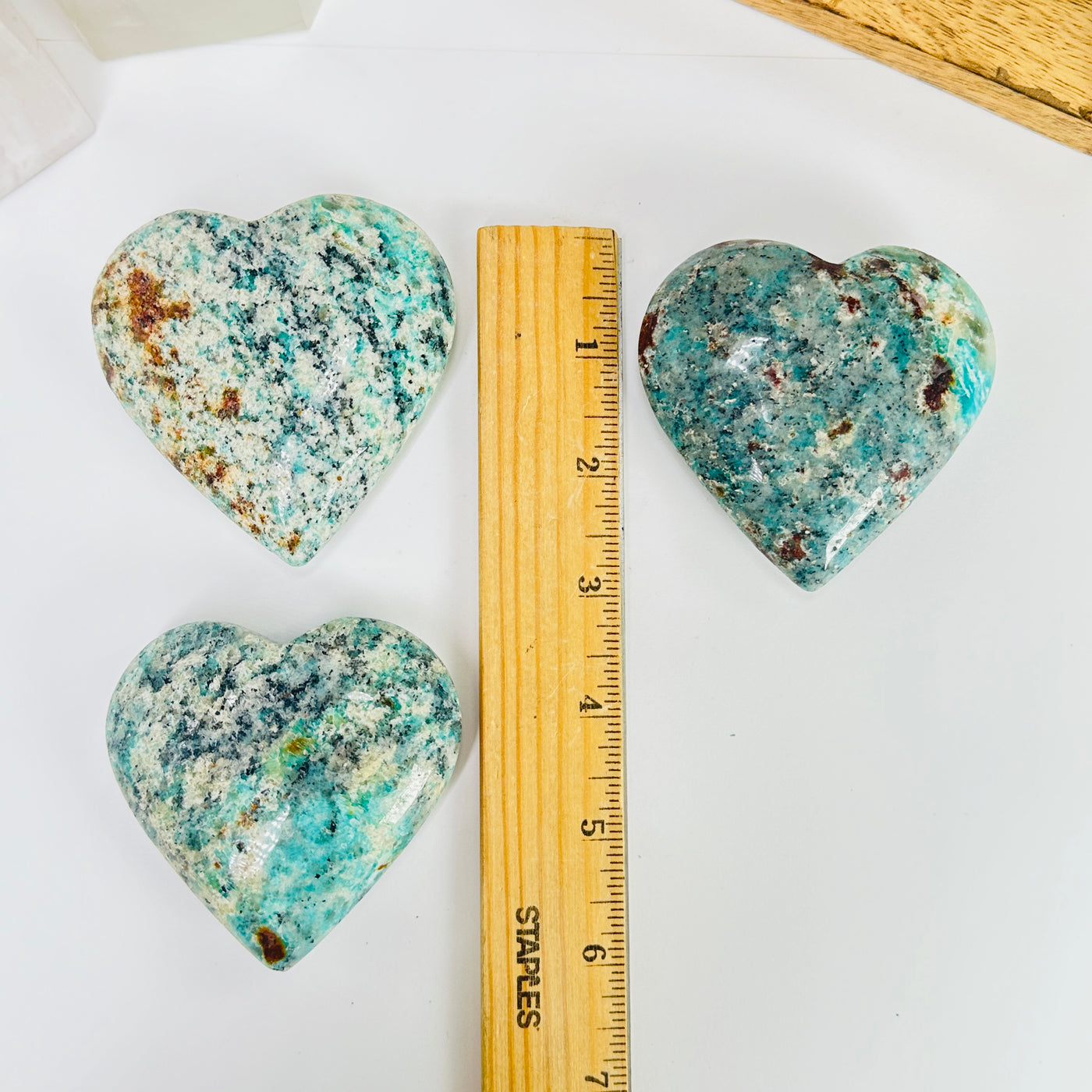 amazonite heart with decorations in the background