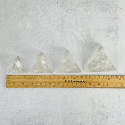 crystal quartz pyramid next to a ruler for size reference