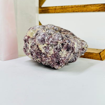 lepidolite with decorations in the background