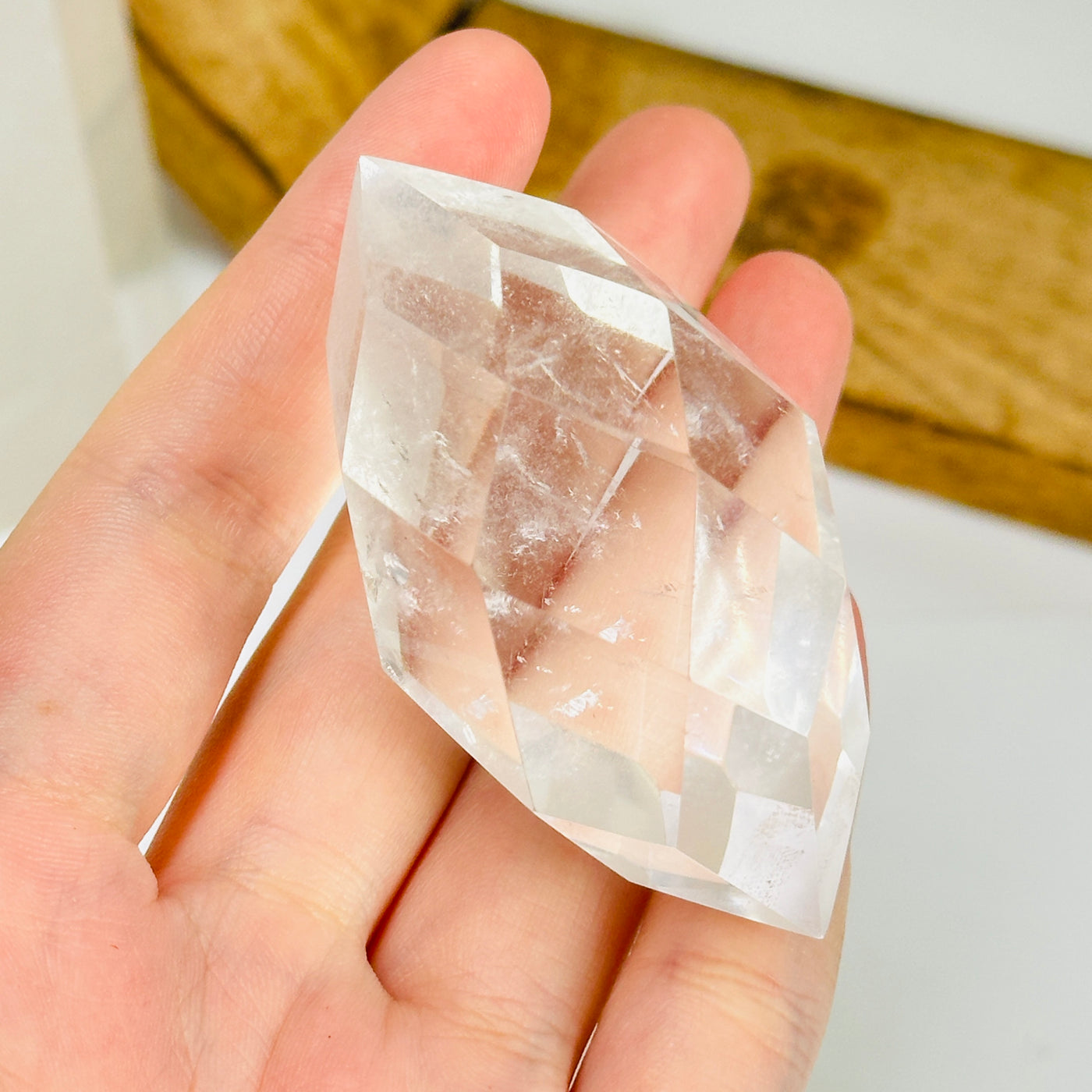 crystal quartz point with decorations in the background