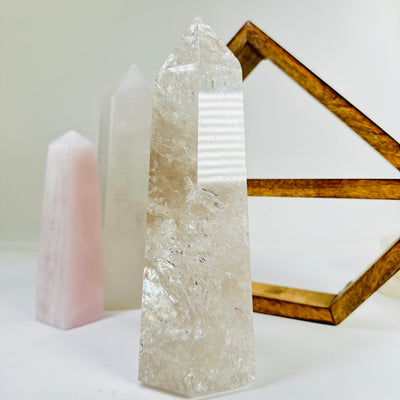 crystal quartz point with decorations in the background