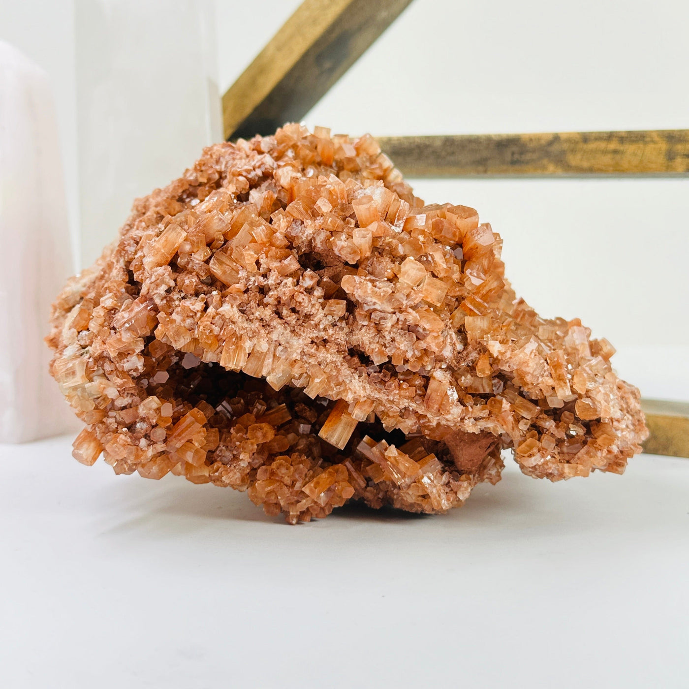 aragonite cluster with decorations in the background