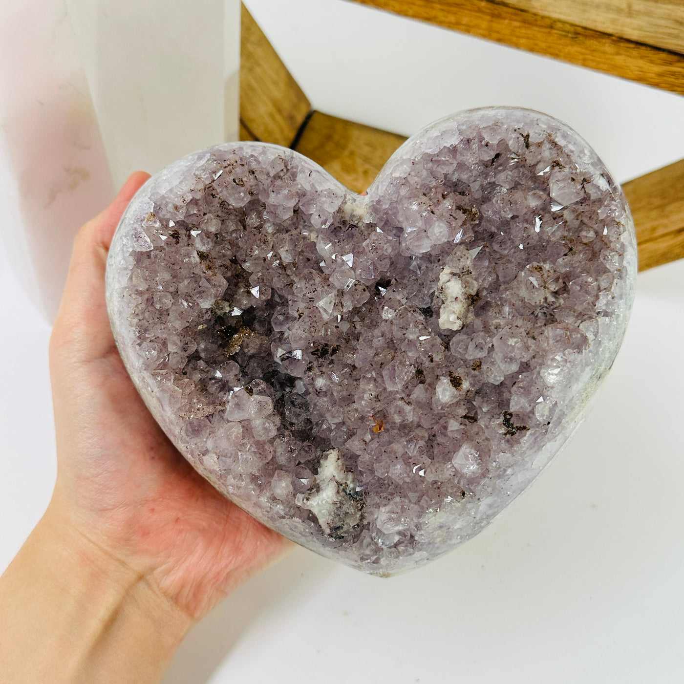 amethyst heart with decorations in the background