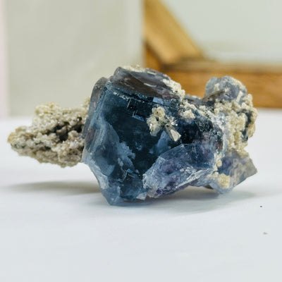 blue fluorite with decorations in the background