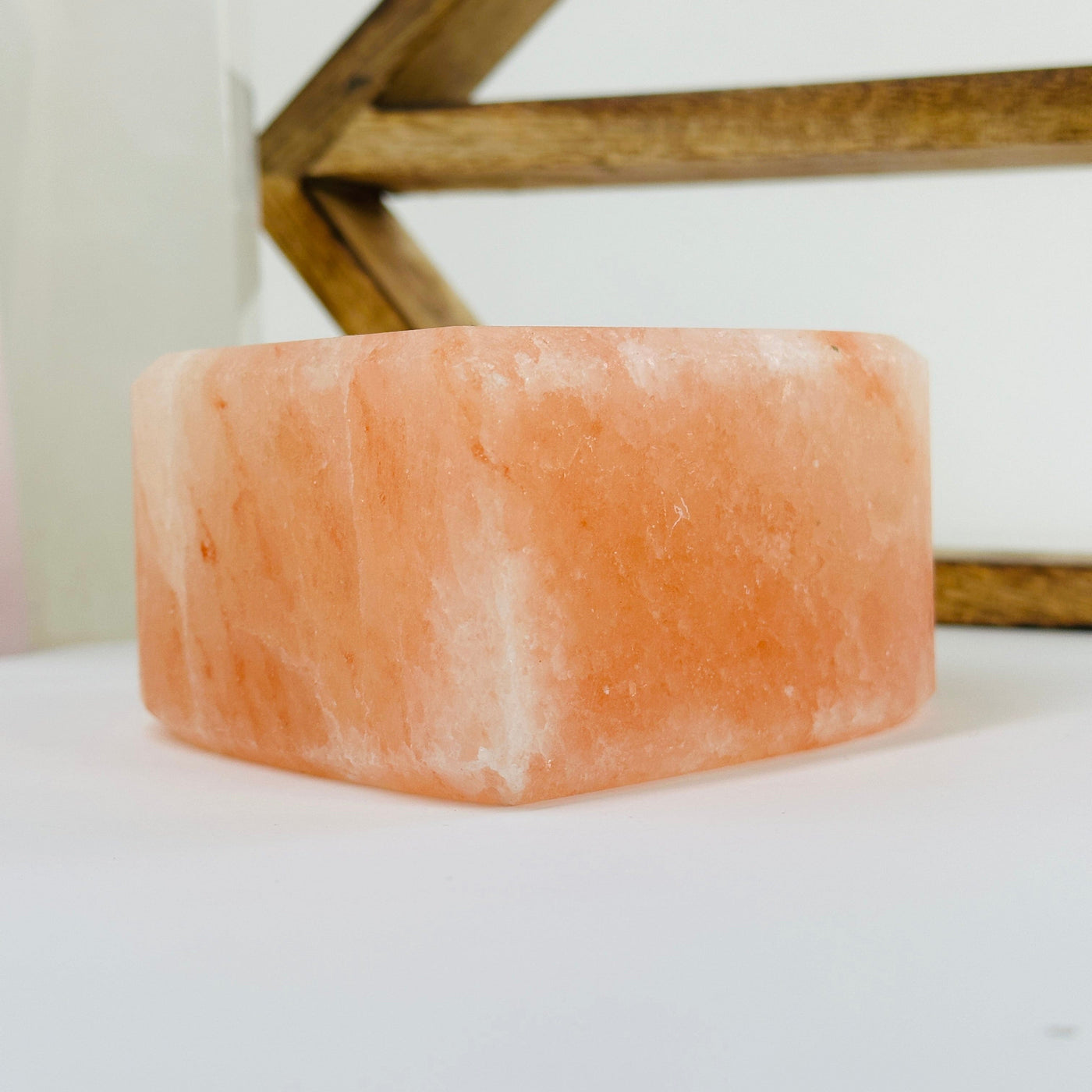 Himalayan salt candle holder with decorations in the background