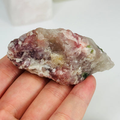 watermelon tourmaline with decorations in the background