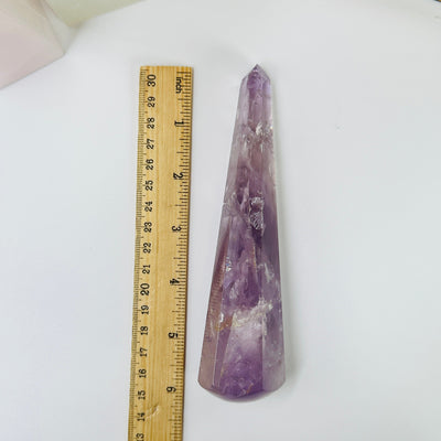 amethyst wand next to a ruler for size reference