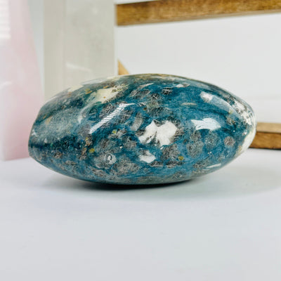 dumortierite cut base with decorations in the background