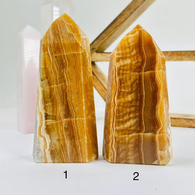 banded calcite points with decorations in the background