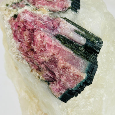 watermelon tourmaline with decorations in the background