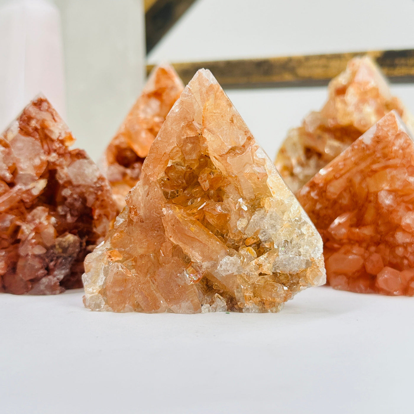 tangerine quartz points with decorations in the background