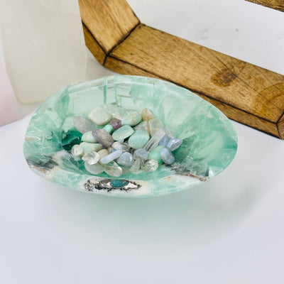 Fluorite Trinket Bowl with decorations in the background and mini crystals 