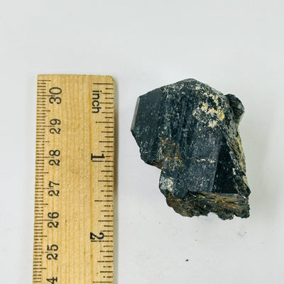 tourmaline next to a ruler for size reference