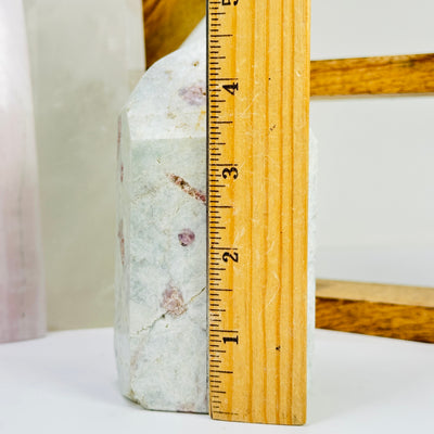 tourmaline point next to a ruler for size reference