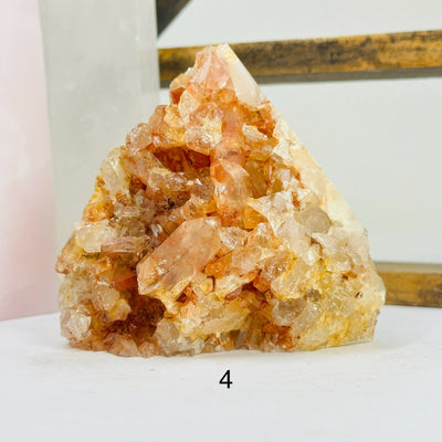 tangerine quartz points with decorations in the background