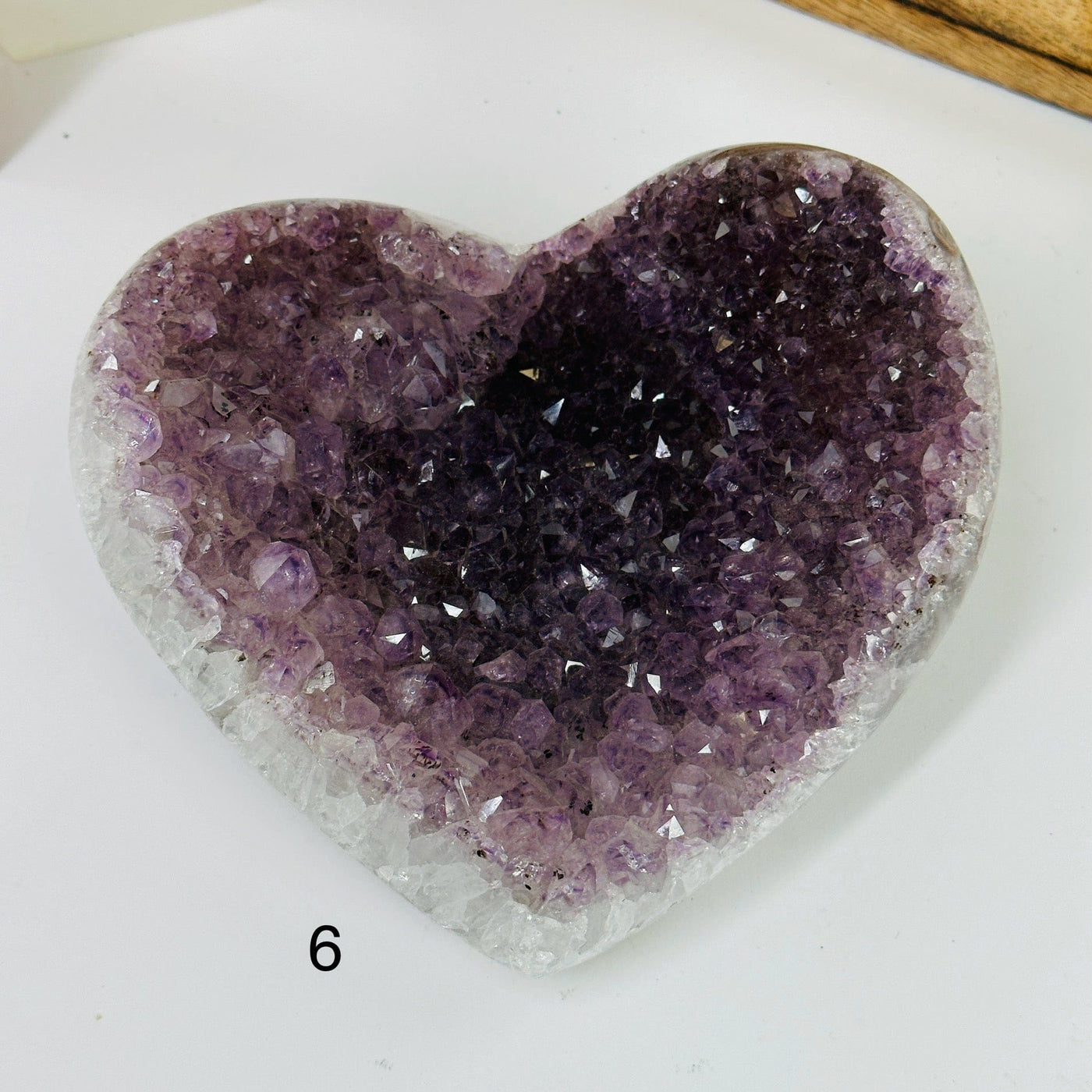 amethyst heart with decorations in the background