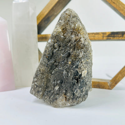 rutilated quartz with decorations in the background