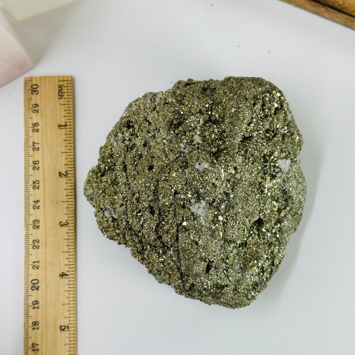 pyrite cluster next to a ruler for size reference