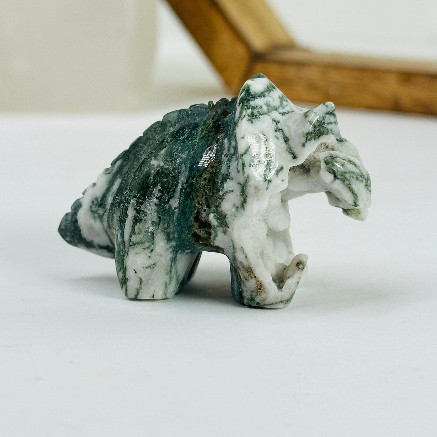 moss agate triceratops with decorations in the background