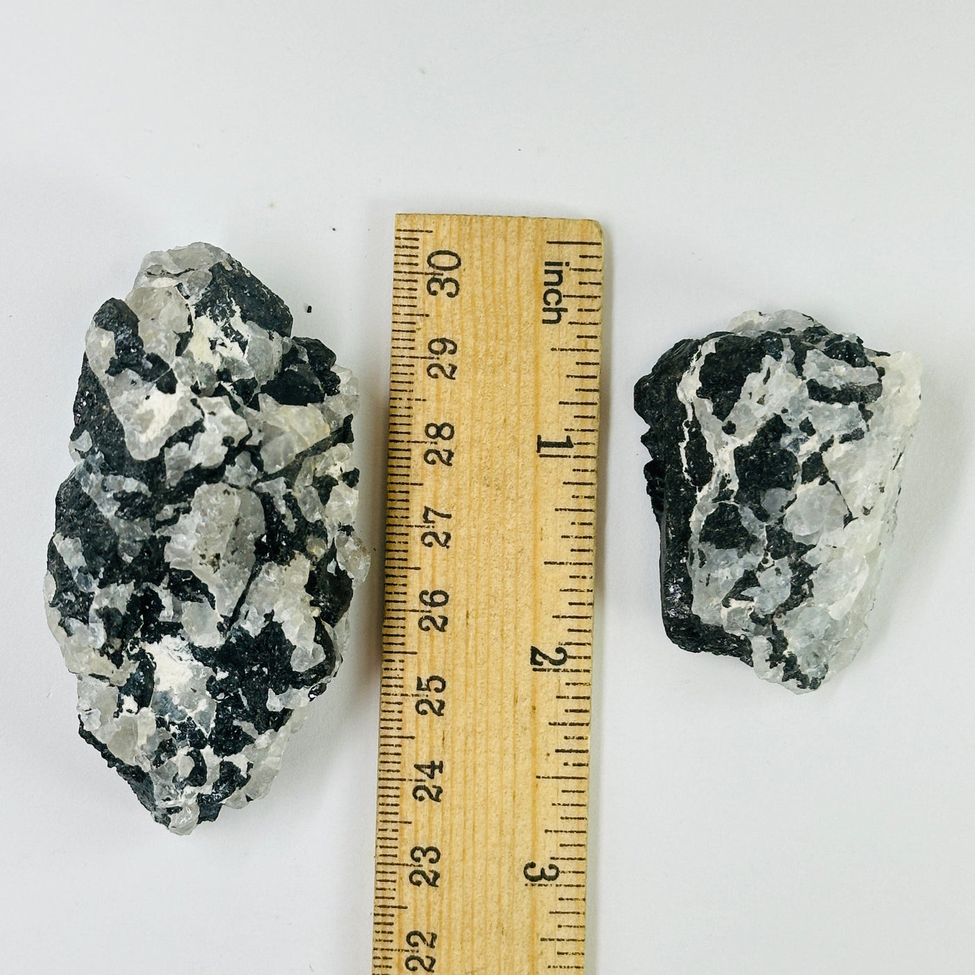 tourmaline cluster next to a ruler for size reference