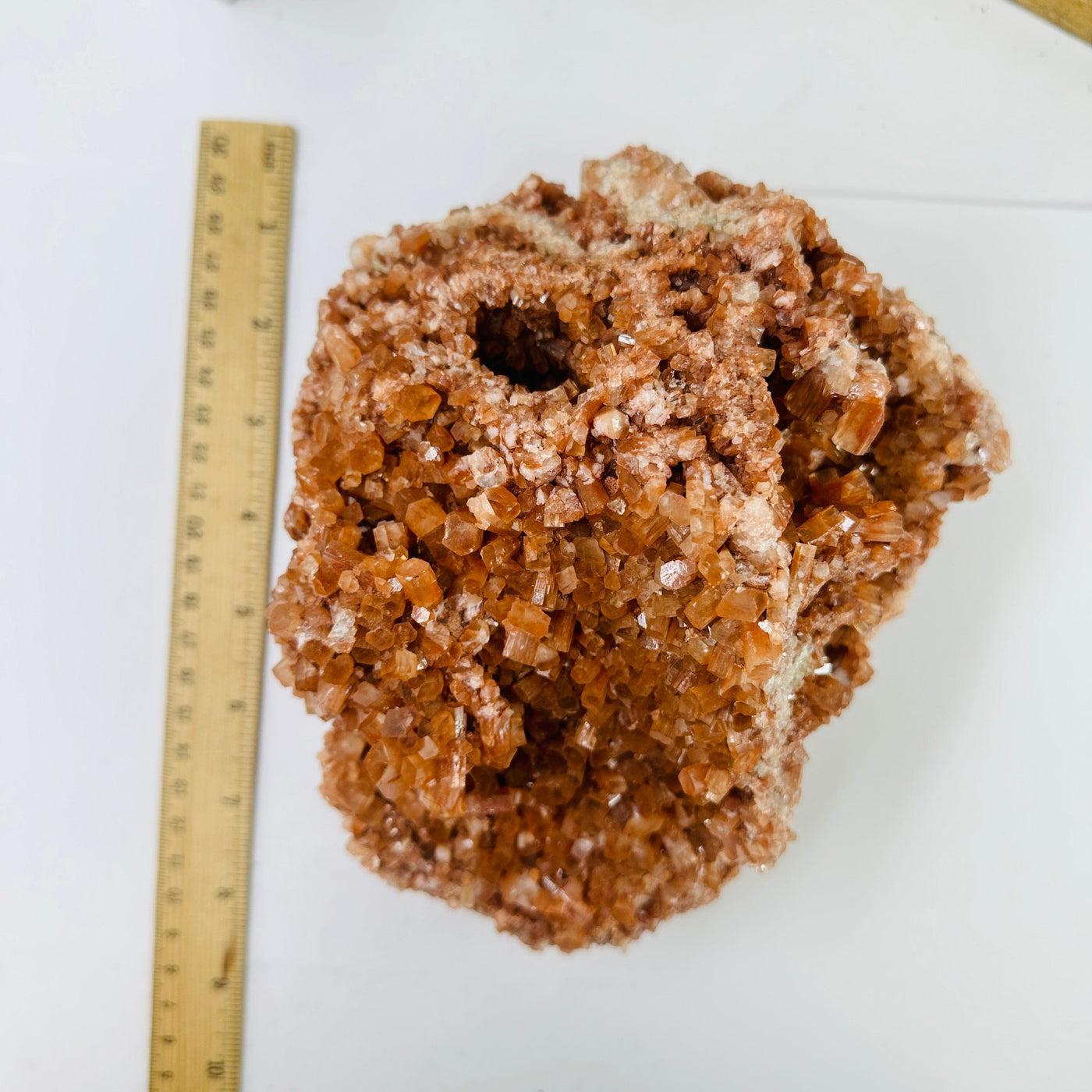 aragonite cluster next to a ruler for size reference