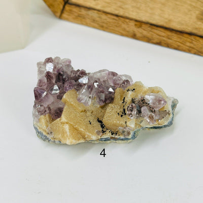 amethyst cluster with decorations in the background