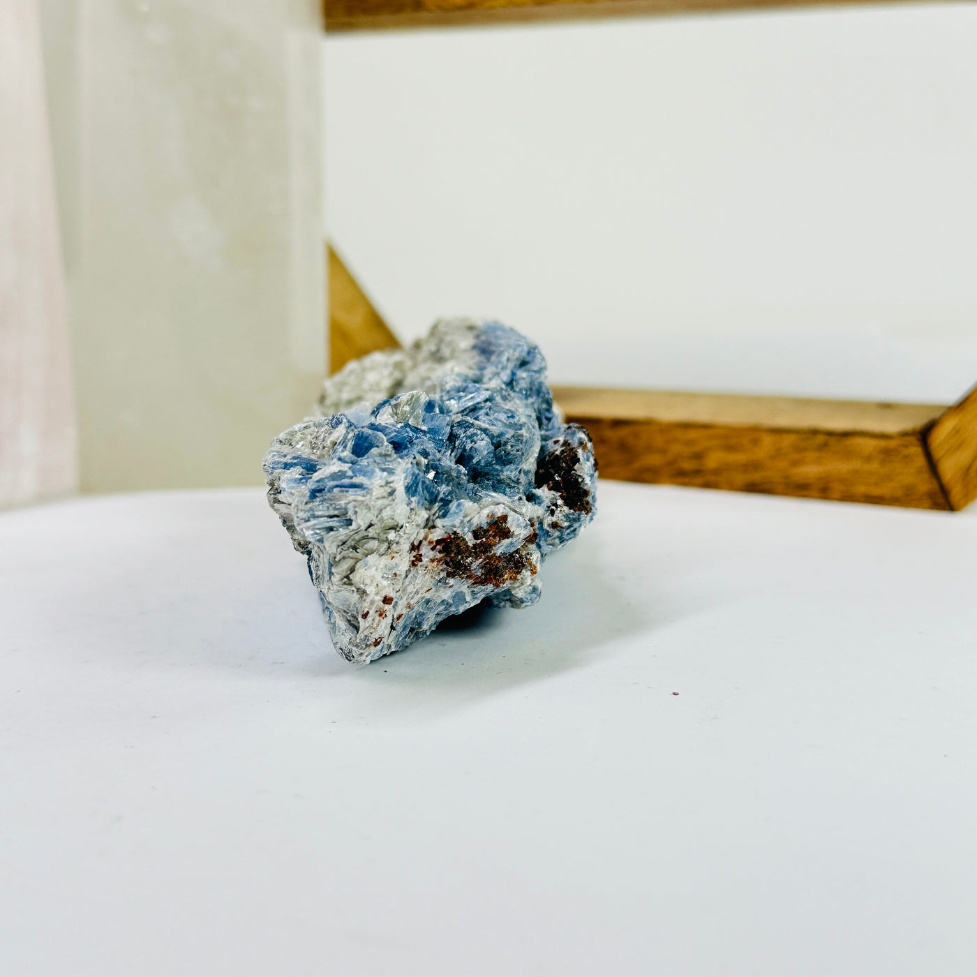 kyanite cluster with decorations in the background