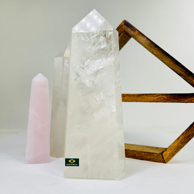 crystal quartz point with decorations in the background