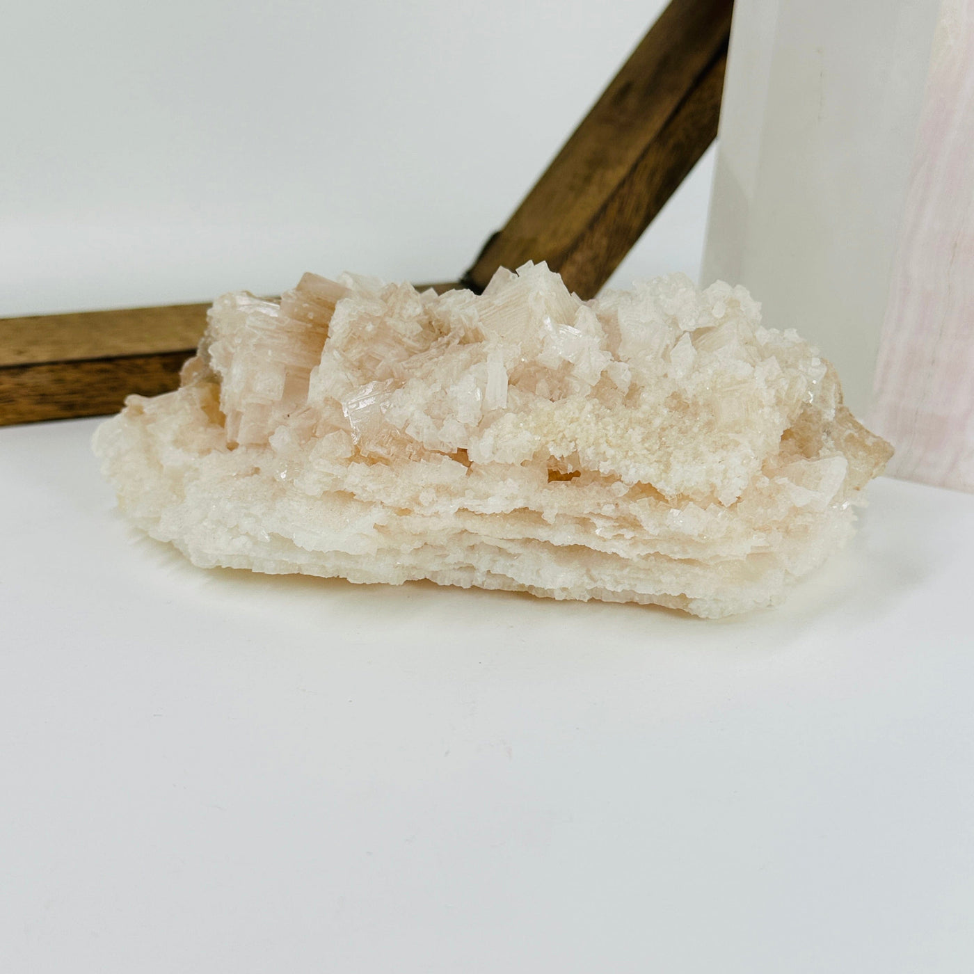 pink halite cluster with decorations in the background