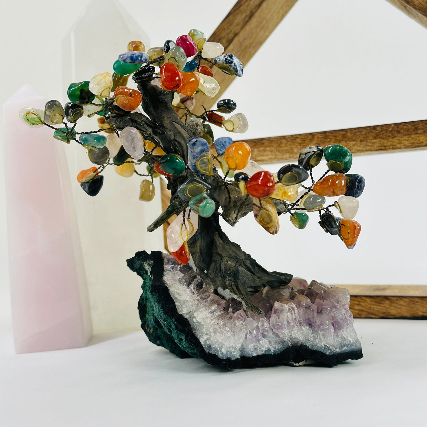 mixed stone tree on amethyst base with decorations in the background