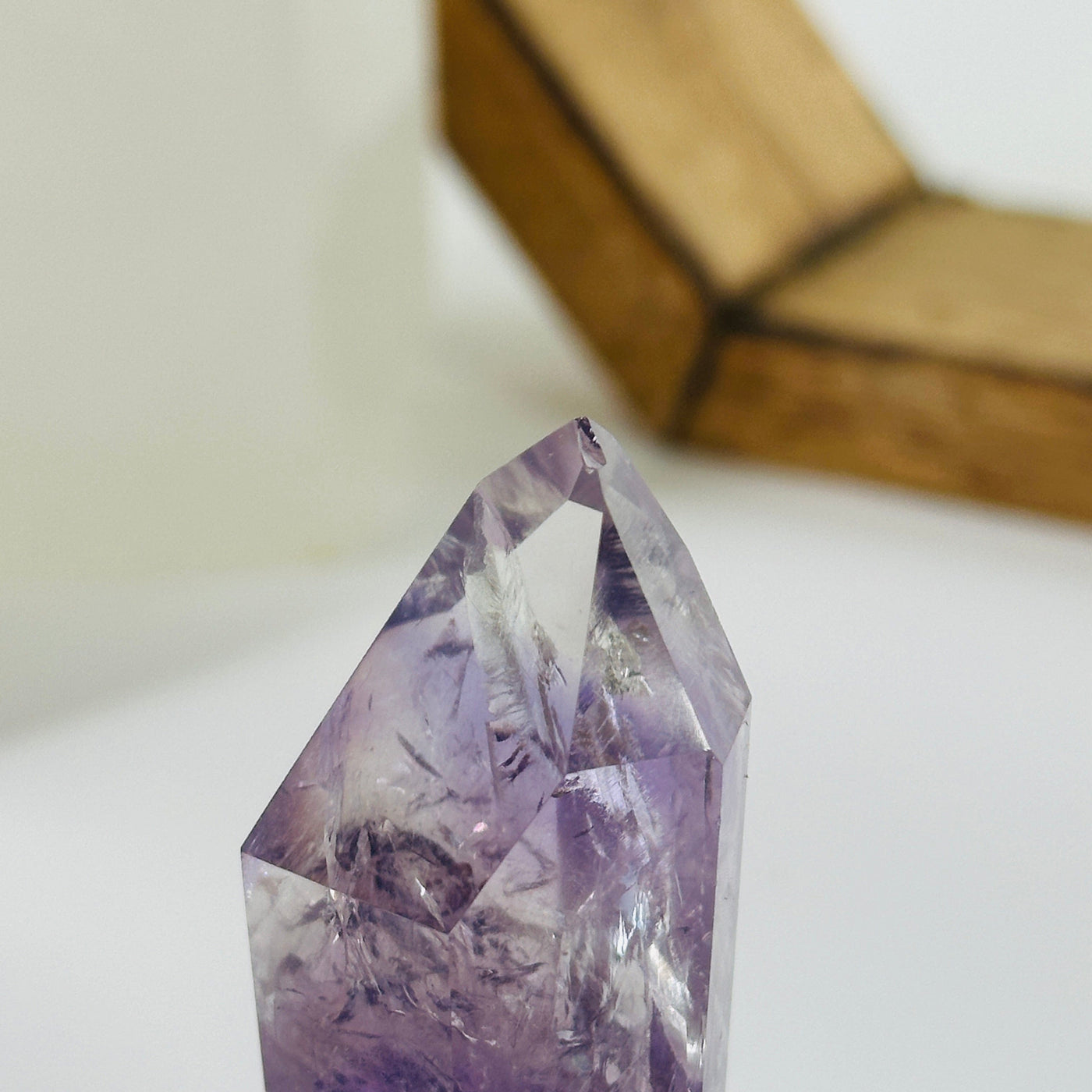 up close shot of chip on tip of amethyst point