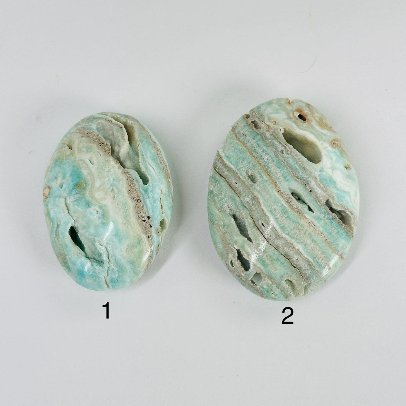 blue aragonite palm stones with decorations in the background