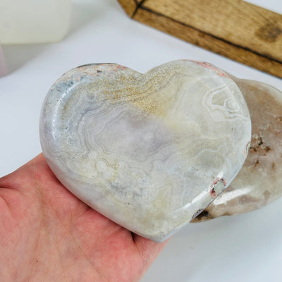 pink amethyst heart with decorations in the background