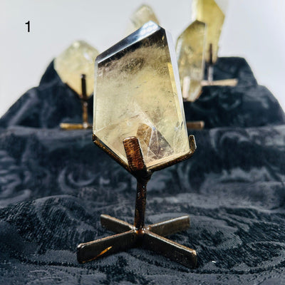 citrine on metal stand with others in the background